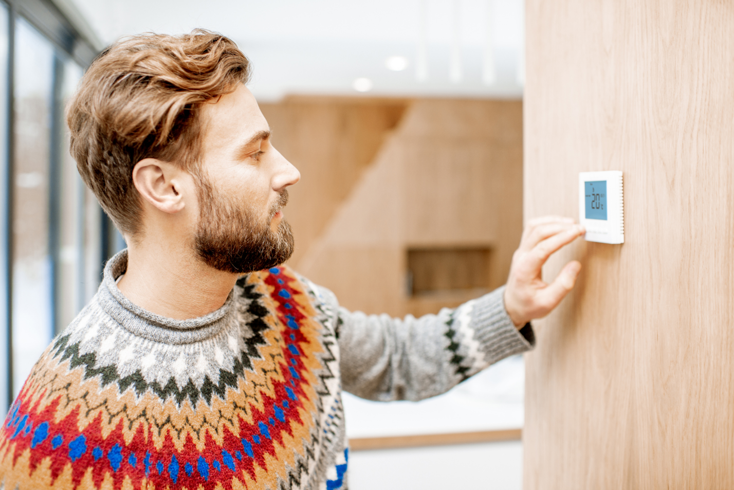 man fixing thermostat