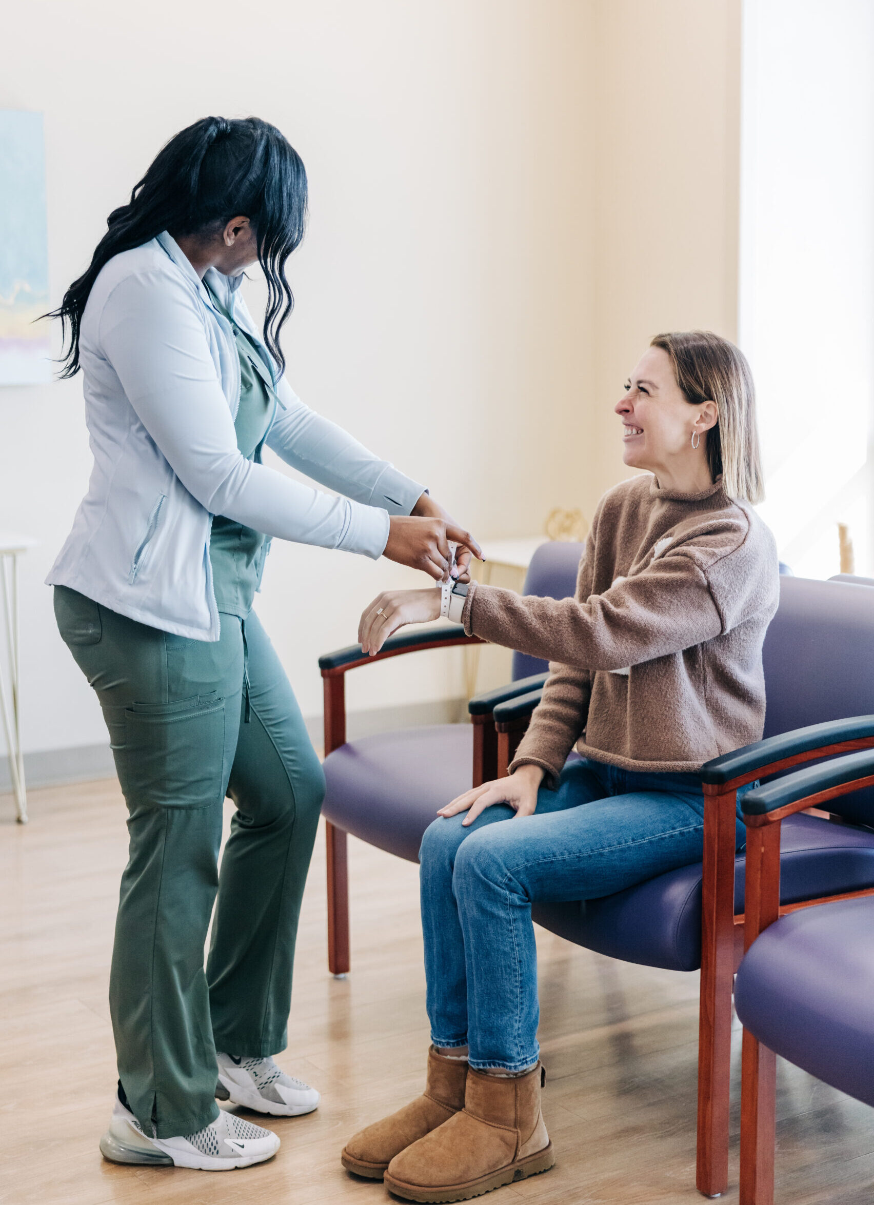 A patient checking in at a facility and met with a smiling staff member.